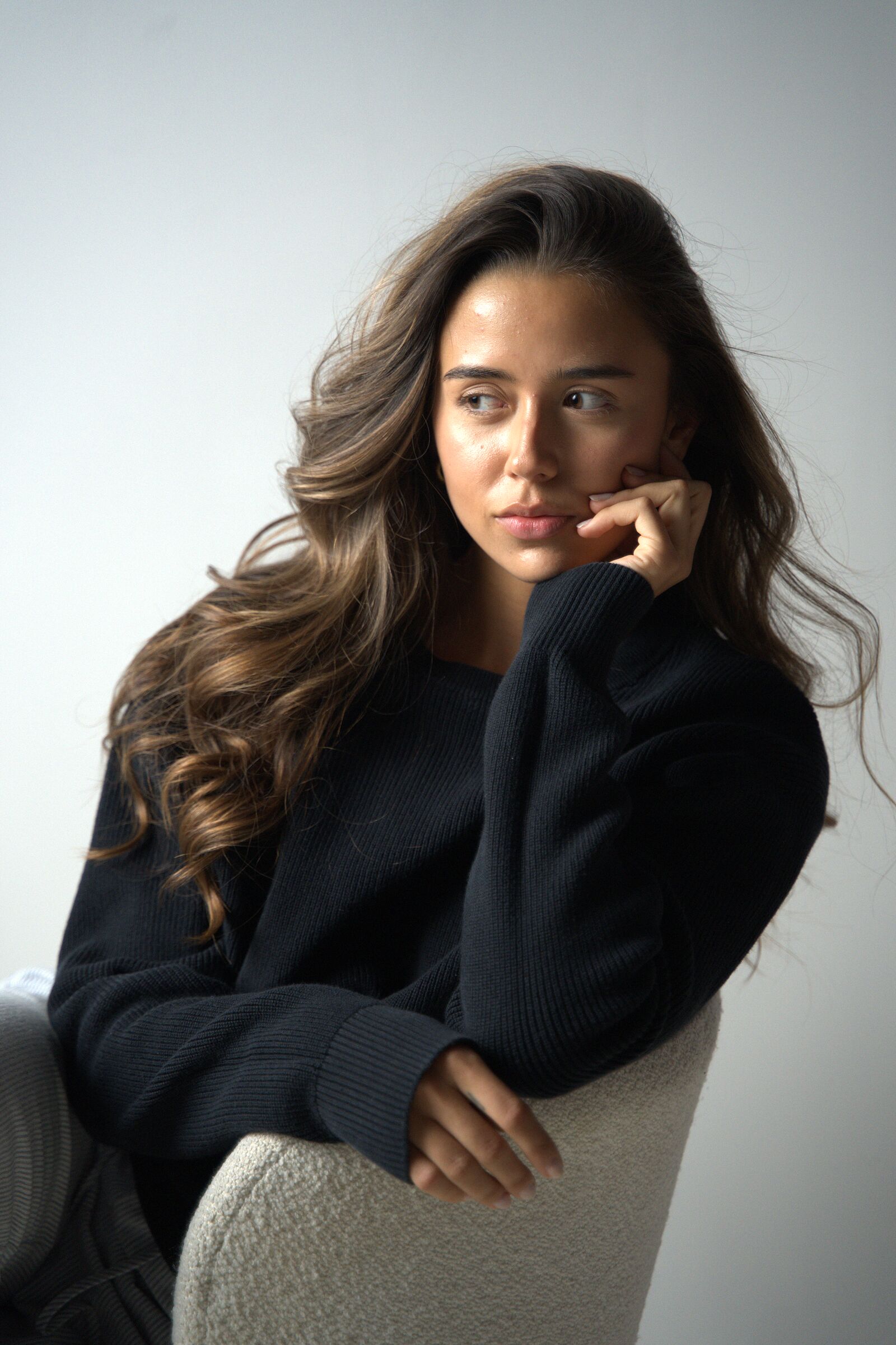 Tanyi Zapata seated in natural window light.